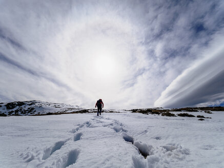 Spain, Sierra de Gredos, man hiking in snow - LAF001631