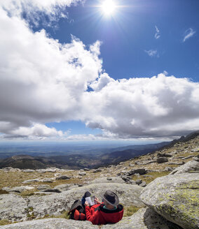 Spain, Sierra de Gredos, hiker sitting in mountainscape - LAF001645