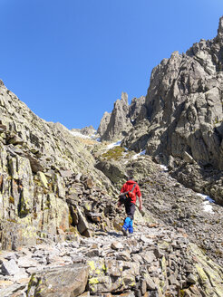 Spain, Sierra de Gredos, man hiking in mountains - LAF001647