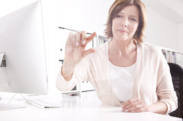 Woman using transparent touchscreen display - MFRF000684