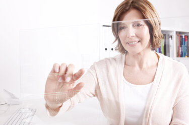 Woman using transparent touchscreen display - MFRF000685