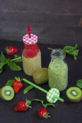 Two glass bottles of different smoothies - YFF000543