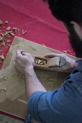 Hands of a carpenter using a hand plane - ABZF000586