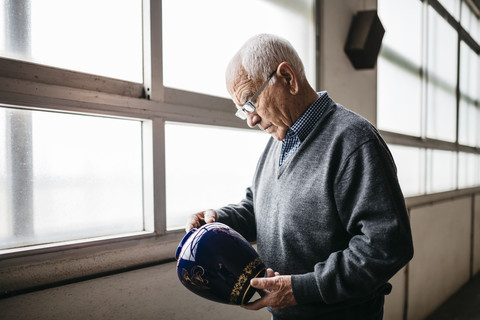 Elderly man reviewing the ceramic vase stock photo