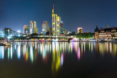 Germany, Frankfurt, lighted skyline with Main River in the foreground - TAMF000490