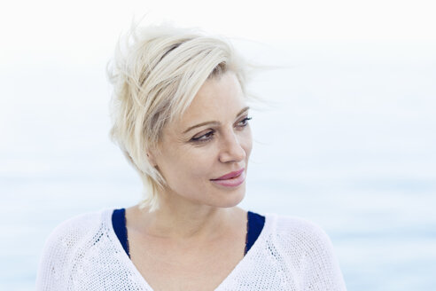 Portrait of blond woman in front of the sea - ONBF000030