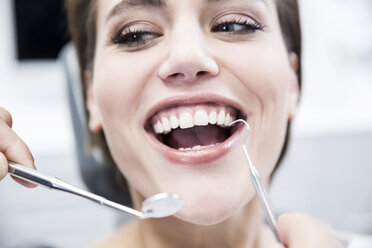 Young woman at the dentist receiving treatment - FMKF002648