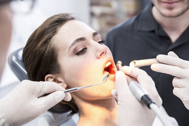 Young woman at the dentist receiving treatment - FMKF002652