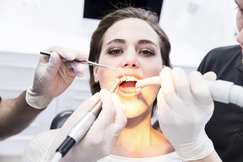 Junge Frau beim Zahnarzt in Behandlung, lizenzfreies Stockfoto