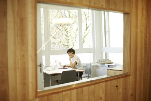 Architect using laptop in her office - TSFF000045