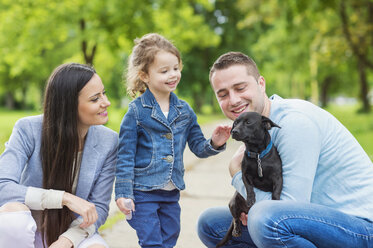 Happy family with dog in park - HAPF000492