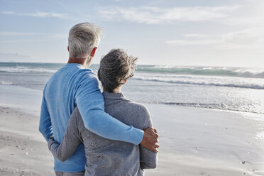 Back view of couple on the beach looking to the sea - RORF000212