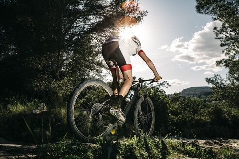 Mountain biker on the move in backlight - JRFF000715