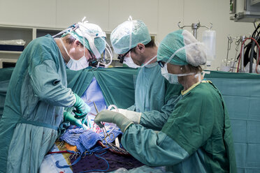 Heart surgeons and operating room nurse during a heart valve operation - MWEF000055