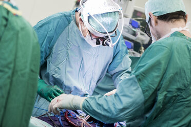Heart surgeons and operating room nurse during a heart valve operation - MWEF000058