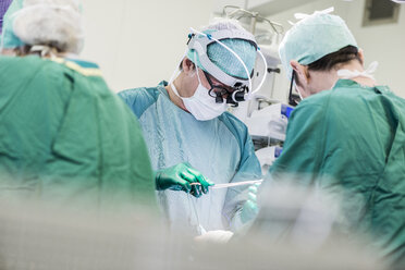 Heart surgeons and operating room nurse during an operation - MWEF000059