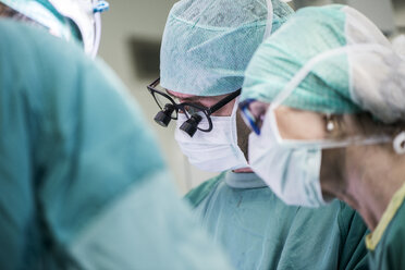 Heart surgeons and operating room nurse during an operation - MWEF000063