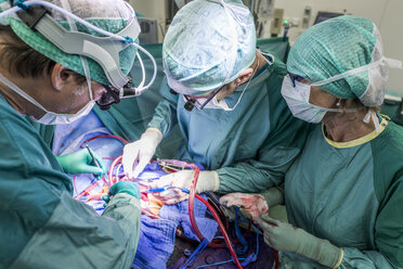 Heart surgeons and operating room nurse during a heart valve operation - MWEF000074