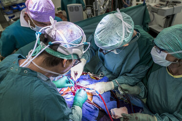 Heart surgeons and operating room nurse during a heart valve operation - MWEF000075