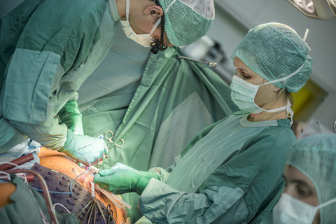 Heart surgeons during a heart operation stock photo