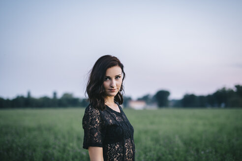 Portrait of a woman wearing a sexy black dress in a meadow - LCU000002