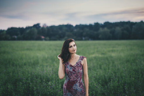 Portrait of a woman wearing a dress in a green field - LCU000010