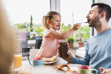 Father and daughter having breakfast together - UUF007426