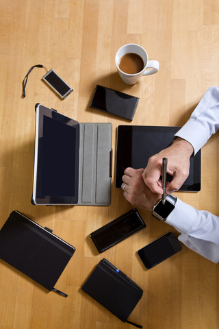 Overhead view of businessman using technology stock photo