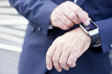 Close-up of businessman using smartwatch - MAEF011762