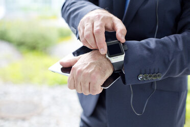 Close-up of businessman using smartwatch - MAEF011763