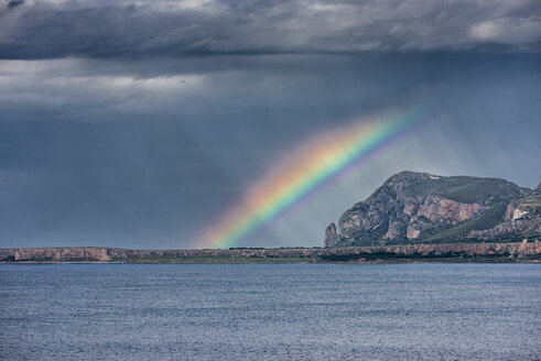 Italy, Sicily, Province of Trapani, climbing rock Monte Monaco, stormy atmosphere and rainbow - HWOF000112