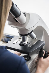 Woman using a microscope - ABZF000626