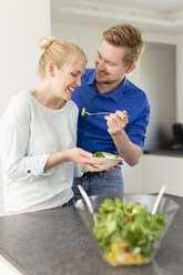 Happy couple in kitchen with salad - SHKF000606