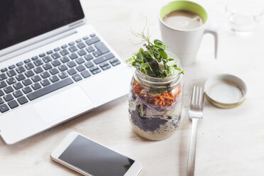 Rainbow salad in jar, smartphone, mug of coffee and laptop - SBDF002928