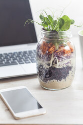 Rainbow salad in jar, smartphone and laptop - SBDF002932