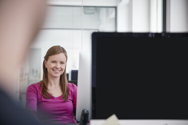 Man and woman working in office, smiling - RHF001510