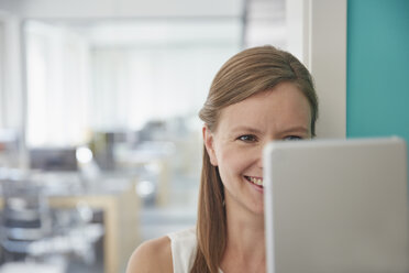 Young businesswoman looking at laptop - RHF001531