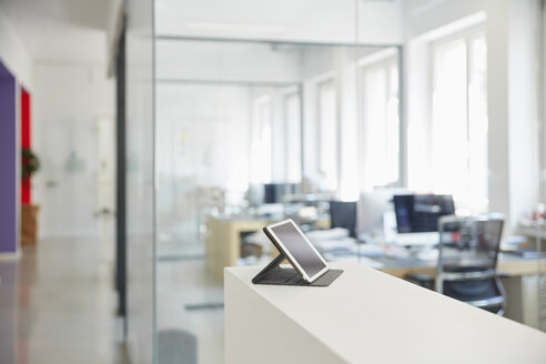 Interior of bright modern office with digital tablet on ledger - RHF001589