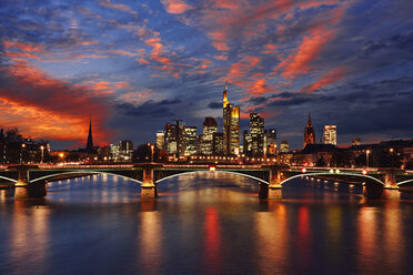 Germany, Frankfurt, view to skyline with Ignatz-Bubis-Bridge and Main River in the foreground by sunset - RUEF001724