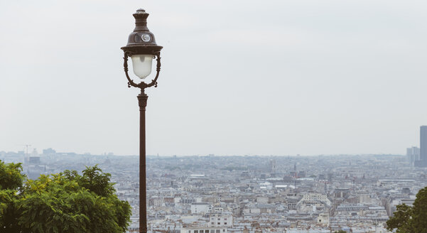 France, Paris, a lamp and cityscape - LCU000013