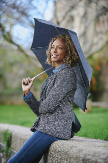 Portrait of smiling woman with umbrella - JCF000021