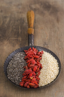 Pfanne mit Chia, getrockneten Wolfsbeeren und Quinoa auf Holz - ODF001388