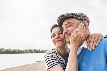 Happy senior man and his daughter head to head - UUF007611