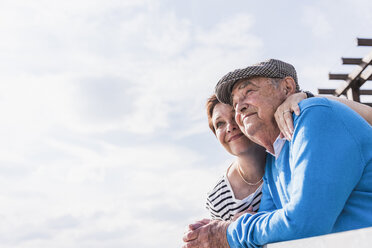 Senior man and his daughter looking together at distance - UUF007618