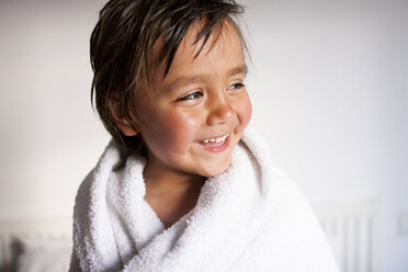 Portrait of smiling little boy with shower towel after taking a bath - VABF000514