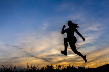 Silhouette einer Joggerin bei Sonnenuntergang - STSF001017