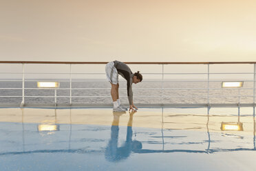 Young man doing exercises on a shipdeck, cruise ship, Mediteranean Sea - ONBF000062