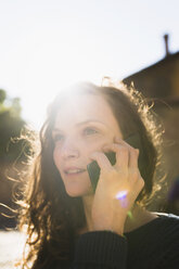 Portrait of smiling woman telephoning with smartphone - BOYF000402