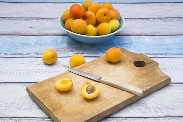 Sliced and whole apricot on wooden board - LVF004931