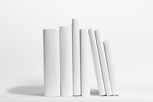 Seven white books in front of white background - SKAF000012